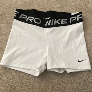 Brand new white Nike pros in size Medium.